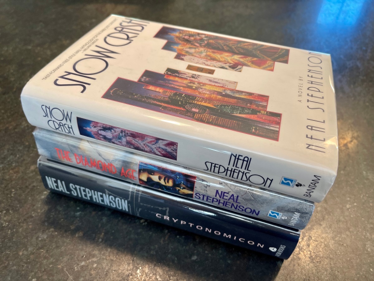 Jamil Moledina's signed copies of Neal Stephenson books.