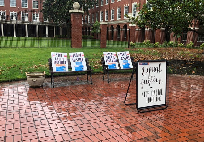Advocates leave signs reading "equal justice" and "stop racial profiling" outside the Knoxville federal courthouse during University of Tennessee professor Anming Hu's trial.