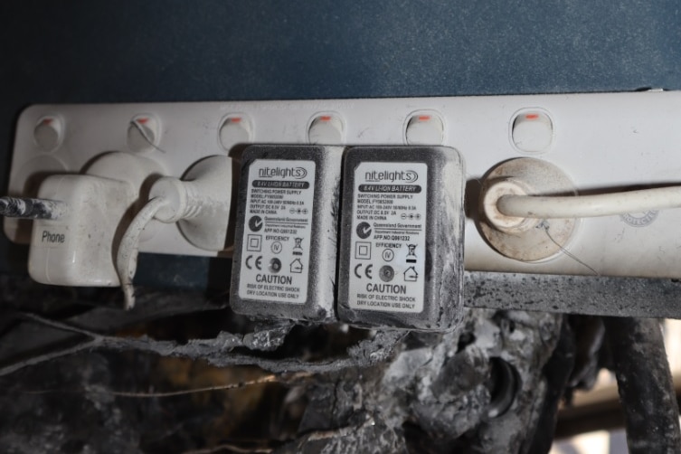 An electrical power board with burned material nearby