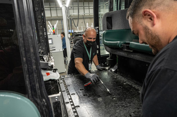 Engineers work on a Zoox Inc., autonomous vehicle at the company's manufacturing facility in Fremont, California, U.S., on Thursday, April 7, 2022. Zoox is a subsidiary of Amazon developing autonomous vehicles that provide Mobility-as-a-Service.