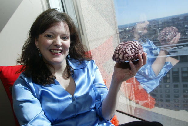 (03/01/06 - Boston, MA) Lisa Harvey, a cognitive scientist recently hired by Arnold Worldwide, poses with a model brain in her new 20th floor office. (030106arnoldjw - Staff photo by John Wilcox - Saved in Photo Thu.)